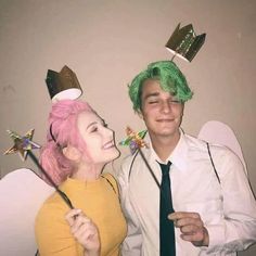 a man and woman dressed up in costumes posing for a photo with one wearing a green wig