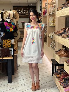 This Adorable Babydoll Dress is the perfect addition to your wardrobe. It's made out of fresh cotton or manta (as its called in Spanish) and it is hand embroidered with cotton string. The design is unique with lace details throughout and the colorful embroidery reflects the Rich Mexican culture! Note: Shoes and Jewelry modeled may be purchased here: Shoes: https://www.etsy.com/es/listing/828873953/zapato-artesanal-de-plataforma-zapato?ref=listings_manager_grid Filigrana Earrings: https://www.ets Multicolor Embroidered Cotton Dress For Vacation, Folk Style Cotton Dress With Embroidered Hem, Cotton Embroidered Dress With Multicolor Embroidery For Vacation, Multicolor Cotton Dress With Floral Embroidery, Multicolor Cotton Embroidered Dress With Floral Details, Multicolor Cotton Embroidered Dress With Embroidered Hem, White Sleeveless Cotton Embroidered Dress, White Sleeveless Embroidered Cotton Dress, Beach Cotton Dress With Multicolor Embroidery