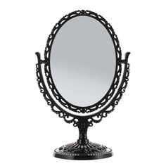 an ornate black metal mirror on a stand