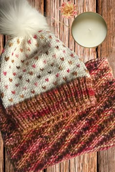 the heart and soul hat / cowl set knitting pattern is shown next to a candle