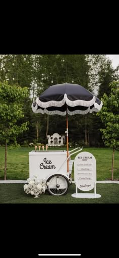 the ice cream cart is decorated with flowers and an umbrella