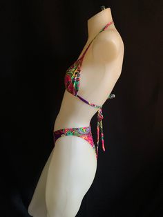 "70's and 80s style string bikini with high leg! Mannequin is a size small and A/B cup for reference. Bra top is lined but not padded for comfort. Bottoms are lined and can be made as a thong, tanga or full coverage (shown). Sizing- PLEASE DOUBLE CHECK YOUR SIZE BELOW BEFORE PLACING AN ORDER. If you send me your measurements (waist, hip and cup size) that would ensure a proper fit. If you need different sizes for the top and bottom, just leave a note in your order. XX small Bust 28 \"- 30 \" A/B Fitted Halter Top With Padded Cups For Beach Season, Adjustable T-back Swimwear For Festivals, Fitted Halter Top For Festivals, Beachwear Style, Adjustable Underwire Halter Top For Summer, Beach Swimwear With Triangle Top And Boning, Festival Fitted Beachwear Swimwear, Beach Swimwear With Boning And Triangle Top, Tropical Party Swimwear With Tie-side Bottom, Tropical Tie-side Bottom Swimwear For Parties