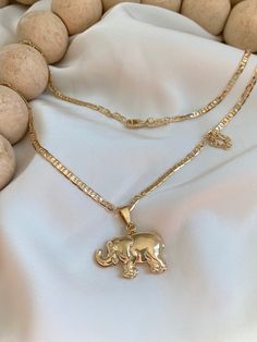 Elephant Necklace♥ The most elegant  & dainty everyday necklace. Featuring a gorgeous golden  elephant charm that dangles from the most delicate & shimmering 18K gold fill chain. A gorgeous necklace that you will reach for everyday. 18K Gold filled  Necklace & Pendant 18" long Mariner chain   CARE: Please take special care of your jewelry. Items should not be worn for bathing or swimming. Store in a cool dry place. Pieces may tarnish over time if above directions are not followed. #Gold #fashion Elephant Necklace Gold Indian, Golden Elephant, Elephant Inspired Jewellery, Elephant Necklace Gold, Sterling Silver Elephant Necklace, Elephant Pendant Necklace, Gold Elephant, Gold Filled Necklace, Elephant Necklace