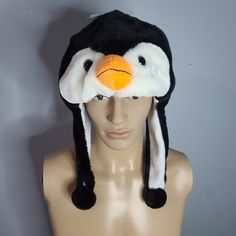 Penguin Fuzzy Stuffed Plush Animal Hat W/ Earmuff Protection Unisex Playful Adjustable Winter Costume Hats And Headpieces, Playful Winter Costume Hats And Headpieces, Black Beanie Costume Hat For Winter, Black Beanie For Winter - Costume Hat, Fun Black Warm Hats, Fun Winter Costume Cap, Winter Novelty Adjustable Costume Hats, Novelty Winter Costume Hats And Headpieces, Playful Black Warm Hats