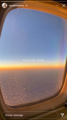 an airplane window with the words head in the clouds