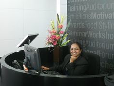 a woman sitting at a desk in an office