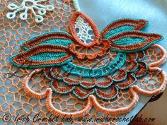 an orange and blue piece of cloth with lace on it