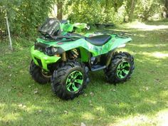 a green four wheeler parked in the grass