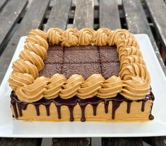 a cake with chocolate icing and peanut butter frosting on top sitting on a plate