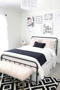 a black and white bedroom with pictures on the wall