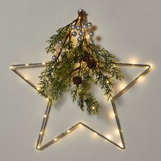 The Lit LED Hanging Star with Greenery in Silver from Wondershop™ is a simple yet stunning decorative piece for the holidays and beyond. This metal star sculpture light is adorned with 40 white LED bulbs that stay lit in a constant glow. It also includes faux pine greenery, pinecones and silver berries for added festive flair. The 14-inch size is perfect for wall and window display and the star is battery operated, so you can easily hang it anywhere you please with the attached metal ring. Wonde Star Sculpture, Snowflake Christmas Lights, Clip String Lights, Christmas Village Sets, Artificial Christmas Wreaths, Silver Theme, Metal Star, Christmas Porch Decor, Wood Christmas Tree