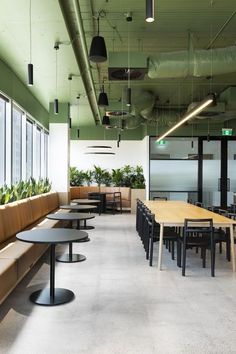 an empty room with tables and benches in it