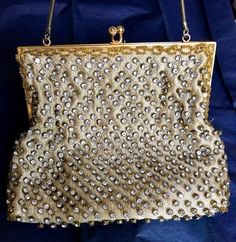 "This is a gorgeous vintage gold tone evening bag/purse.  The frame is gold, the gold silk is embellished with  rhinestones and gold seed beads on the edges.  The inside is beige satin in great condition.  There are two rhinestones missing on the plead on the side - hardly visible.  The chain is in excellent condition as well as the clasp.   A beautiful bag for a special occasion.  Measurements Height- 6 3/4 Width - 8\" Drop - 6 1/2\" My store strives for excellence, honesty and transparency.  P Embellished Belt, Evening Purse, Gold Silk, Vintage Purse, Beautiful Bags, Clutch Handbag, Gold Beads, Michael Kors Monogram, Vintage Gold