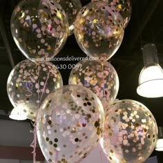 large clear balloons with gold confetti on them