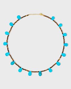 This captivating necklace showcases the rich warmth of Tiger’s Eye paired with the bold blue of Turquoise drops. It combines earthy tones with vibrant pops of color, creating a balanced and eye-catching accessory. 14 karat yellow gold Tigers Eye 16 to 17 inches length 3mm bead size Style # JJ-NAZ-405 UPC 810109745944 Turquoise Teardrop Faceted Beads Jewelry, Turquoise Teardrop Faceted Jewelry, Turquoise Briolette Gemstone Bead Necklaces, Turquoise Briolette Gemstone Necklace, Turquoise Faceted Briolette Necklaces, Turquoise Faceted Briolette Necklace, Turquoise Teardrop Necklace With Faceted Beads, Primal Instincts, Playful Pose