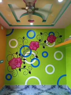 a green room with flowers painted on the wall