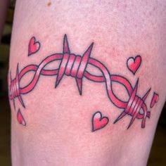 a tattoo with hearts and barbed wire on the side of someone's leg,