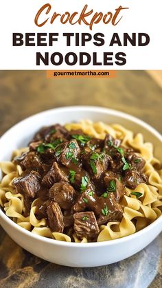 beef tips and noodles in a white bowl with text overlay that reads crockpot beef tips and noodles