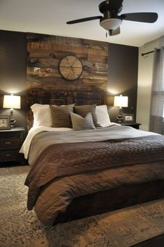 a bedroom with a bed, ceiling fan and wooden paneled headboard on the wall