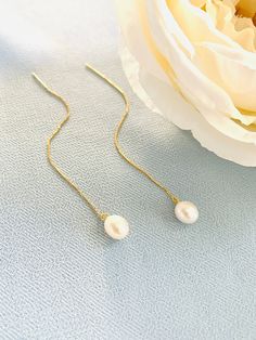 These elegant long pearl earrings are a sought-after option for bridal parties, combining style with ease of wear. They make for a fabulous addition to wedding jewelry, suitable for brides, bridesmaids, and the mother of the bride.  Please note: We use freshwater pearls therefore, they may vary slightly in shape, shade, and size. We will try our best to make sure that is the perfect match and that the overall look is unified.  🖤 M A T E R I A L S  *  A N D  *  S I Z E  🖤 ❇️ MATERIAL & METAL: 9 Pearl Dangle Threader Earrings For Weddings, Pearl Threader Earrings With Pearl Drop For Weddings, Pearl Drop Threader Earrings For Wedding, Wedding Threader Earrings With Pearl Charm, Gold Pearl Threader Earrings For Wedding, Wedding Pearl Charm Threader Earrings, Wedding Pearl Drop Dangle Threader Earrings, Wedding Pearl Threader Earrings With Pearl Charm, Delicate Pearl Drop Threader Earrings For Wedding