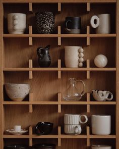 the shelves are filled with different kinds of cups