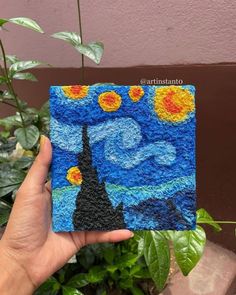 someone is holding up a piece of art made to look like the starry night