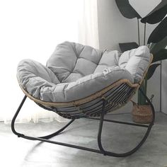 a chair that is sitting next to a plant