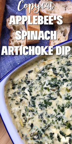 a bowl of spinach artichoke dip with bread in the background