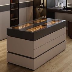 a modern kitchen with an island made out of wood and glass counter tops, in the middle of a hardwood flooring area