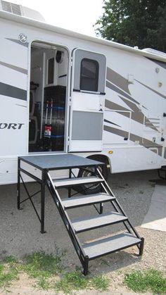 an rv with stairs leading to the door