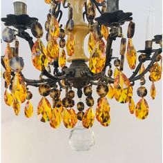 a chandelier with yellow and brown crystals hanging from it's centerpiece