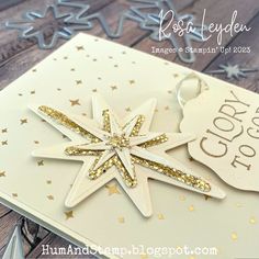 a close up of a christmas ornament on a card with some confetti