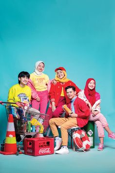 group of people sitting in front of a shopping cart