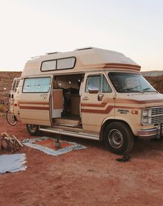 an old van is parked in the desert