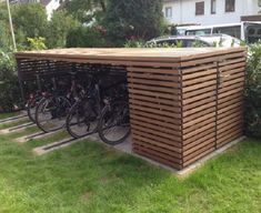 several bikes are parked in front of a wooden structure