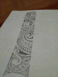 a pencil drawing of a decorative design on a piece of paper that is sitting on a table