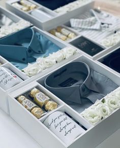 several boxes filled with different types of men's shirts and ties on top of each other