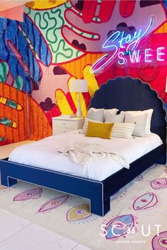 a bedroom with colorful wallpaper and a large bed