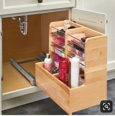 an open drawer in a kitchen filled with beauty products