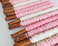 there are many pink and white pretzels lined up