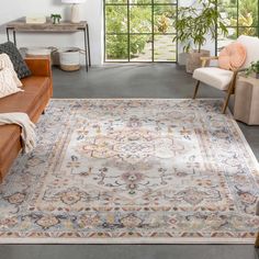 a living room area with couches and rugs