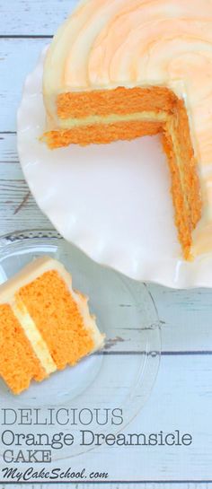 an orange cake with white frosting on a plate next to a slice cut out