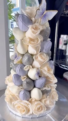 a wedding cake decorated with flowers and butterflies