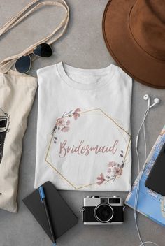 a t - shirt with the word bridesmaid on it next to other items