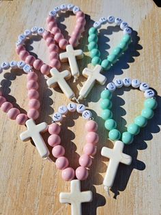 These handmade mini personalized rosaries are a perfect gift for the little loved ones at your special occassion as a keepsake!  Each rosary is made using 8mm coated glass beads and 7mm letter beads, 20x30mm howlite stone cross and nylon thread  Please add name for personalization You can order 1 or scroll down in quantity for discounted bulk orders Personalized Pink Rosary Bracelet For Baptism, Handmade Pink Rosary For Baptism, Pink Cross Rosary Bracelet Gift, Pink Cross-shaped Rosary Bracelet Gift, Mini Rosaries, Personalized Rosary, Stone Cross, Gift For Students, Christening Favors