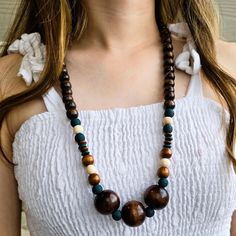 Embrace the beauty of nature with this handcrafted wooden bead necklace, perfect for those who love earthy, bohemian-inspired jewelry.  Made from high-quality, eco-friendly wood, this necklace offers a simple yet stylish look that complements any outfit.  Its natural tones and organic texture make it an ideal accessory for casual, everyday wear or as a statement piece for special occasions. FEATURES: - 28' Long and easily fits over head - Handcrafted with natural, sustainably sourced wooden bead Elegant Adjustable Wooden Beaded Necklace, Nature-inspired Beaded Necklace With Wooden Beads, Multi-strand Wooden Beaded Necklaces For Festivals, Nature-inspired Wooden Beaded Necklace, Wood Beads Jewelry, Brown Multi-strand Wooden Beaded Necklaces, Coastal Jewelry, Beach Wedding Jewelry, Wooden Bead Necklaces