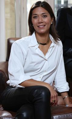 a woman sitting on top of a brown chair