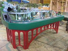 a table with a train set on it in a room that is being worked on