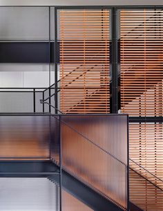 an abstract photo of wooden slats on the side of a building with metal balconies