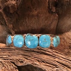 "Vintage Authentic Beautiful Navajo Zuni Sterling Silver Genuine 7 Stone Turquoise Hand Stamped Bracelet Cuff Very Sturdy Native American Navajo Zuni Tribe Sterling Silver Bracelet Cuff measuring 5/8 \" in width. The Cuff length is 5.5\" and 1 1/8 total 6 5/8\" and is Inlaid with 7 Beautiful genuine Sleeping Beauty turquoise stones. Absolutely Amazing.. and perfect for Native American jewelry collectors Sterling Silver Handcrafted by Navajo Artist Weighs 52g. Perfect for a Gift ❤️ Turquoise, or Silver Bracelet Cuff, Navajo Turquoise Jewelry, Handstamped Bracelet, Navajo Bracelet, Stamped Bracelet, Turquoise Bracelet Cuff, Sleeping Beauty Turquoise, Turquoise Stones, Bracelet Cuff